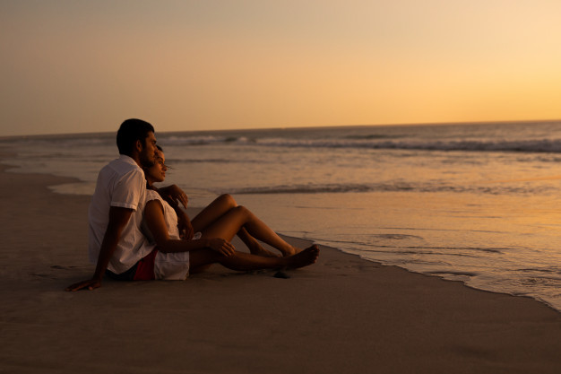 Couple looking at Ocean at Sunset