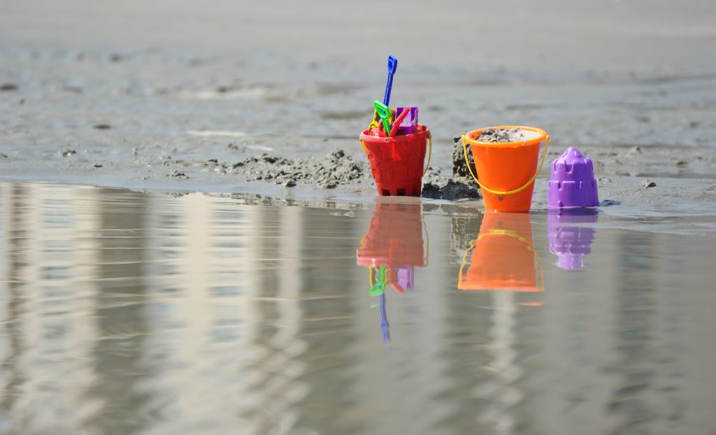 beach pails with shovels, sand and water from the ocean