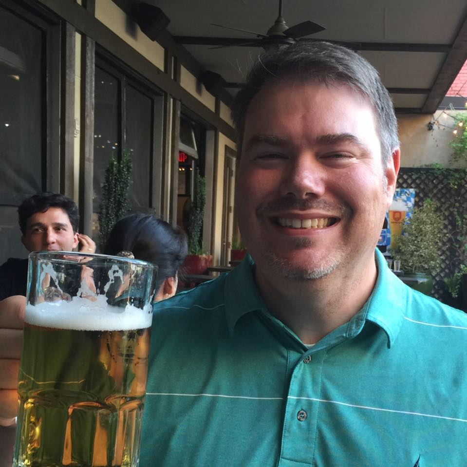 Man with beer smiling